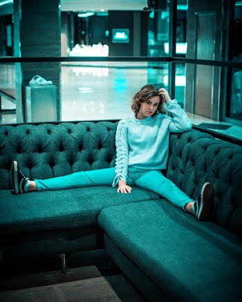 Photo of Woman Sitting on Sofa