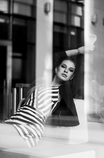 Photo of Woman Sitting on Sofa Posing