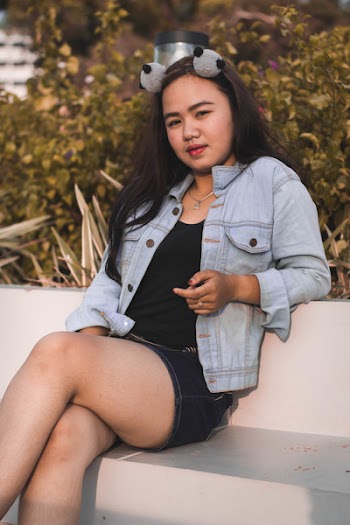 Photo of Woman Sitting on Stone Bench