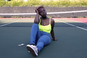 Photo Of Woman Sitting On Tennis Court