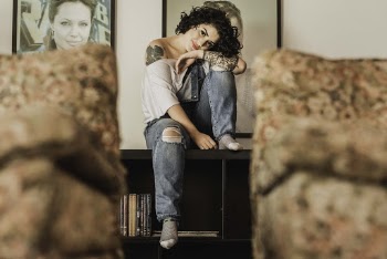 Photo Of Woman Sitting On Top Of Bookshelf