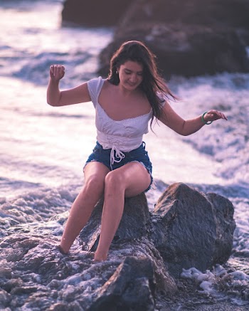Photo Of Woman Sitting On Top Of Rock