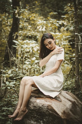 Photo Of Woman Sitting On Tree