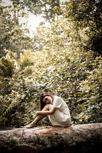 Photo Of Woman Sitting On Tree