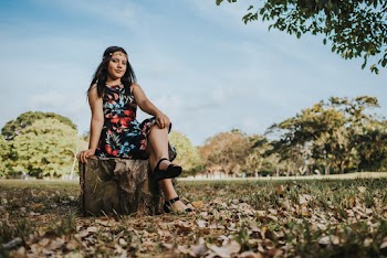 Photo of Woman Sitting on Tree Stump
