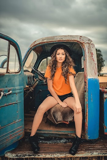 Photo Of Woman Sitting On Truck 
