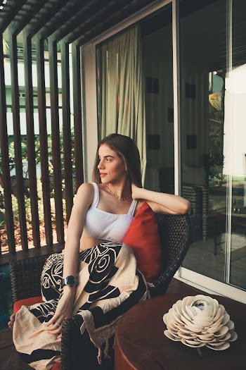 Photo of Woman Sitting on Wicker Chair