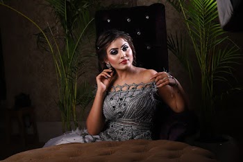 Photo of Woman Sitting on Winged Chair