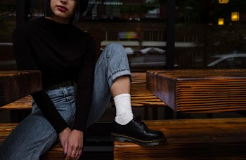 Photo of Woman Sitting on Wooden Bench