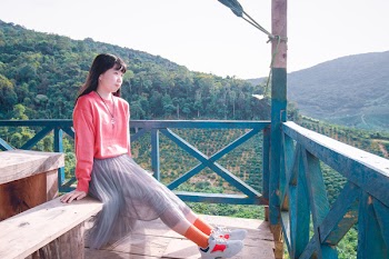 Photo of Woman Sitting On Wooden Bench