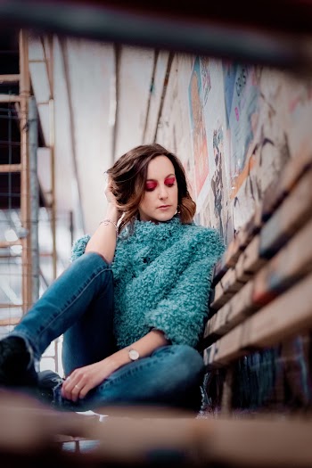 Photo of Woman Sitting on Wooden Bench Posing
