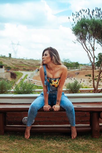 Photo of Woman Sitting on Wooden Bench Posing