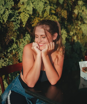 Photo of Woman Sitting on Wooden Chair