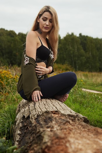 Photo Of Woman Sitting On Wooden Log