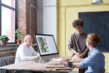 Photo Of Woman Sitting On Wooden Table