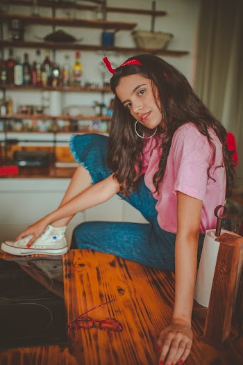 Photo of Woman Sitting on Wooden Table