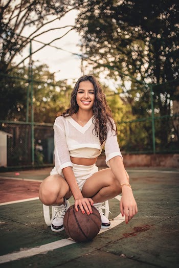 Photo of Woman Sitting While Holding Basketball