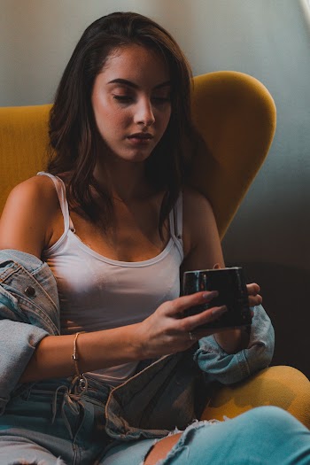 Photo of Woman Sitting While Holding Mug