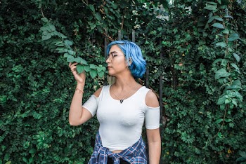 Photo of Woman Smelling Leaves