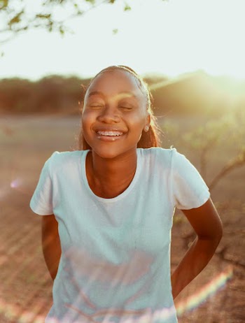 Photo of Woman Smiling While Wearing White Shirt