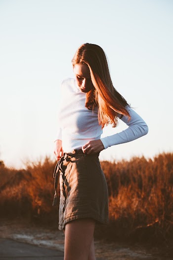 Photo of Woman Standing and Looking Downwards