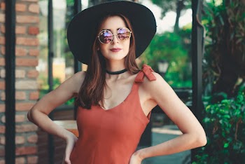 Photo of Woman Standing and Wearing Sun Hat