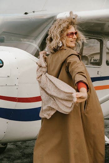 Photo Of Woman Standing Beside Aeroplane
