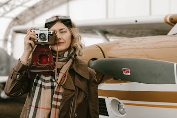 Photo Of Woman Standing Beside Airplane