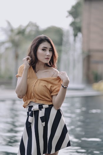 Photo of Woman Standing Beside Body of Water
