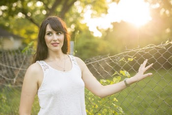 Photo of Woman Standing Beside Chain-Link Fence