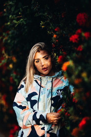 Photo of Woman Standing Beside Hedge