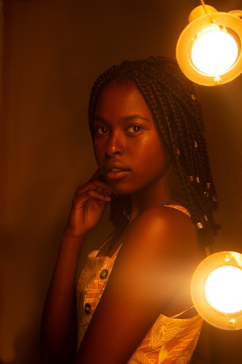 Photo of Woman Standing Beside Lamps Posing