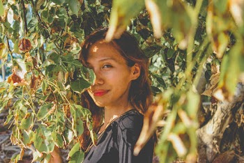 Photo of Woman Standing Beside Leaves
