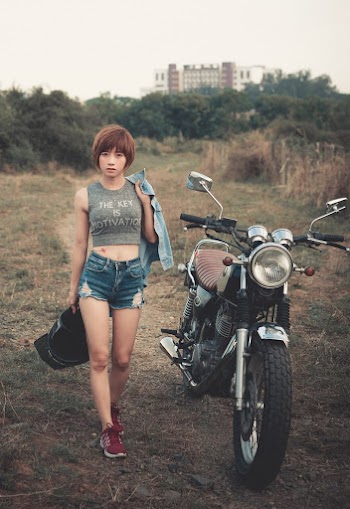 Photo Of Woman Standing Beside Motorcycle