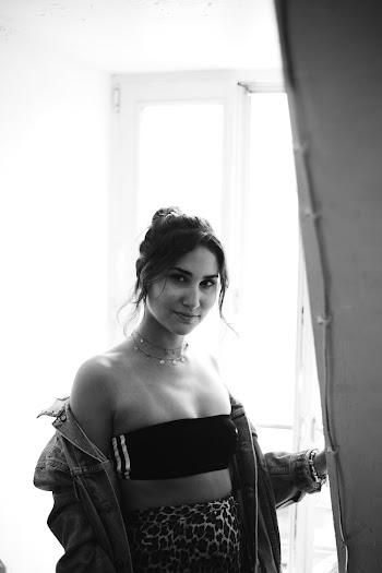 Photo Of Woman Standing Beside The Wall