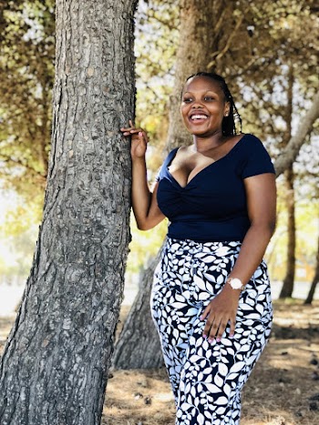 Photo of Woman Standing Beside Tree