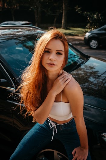 Photo Of Woman Standing Beside Vehicle