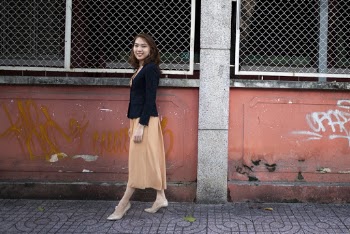 Photo of Woman Standing Beside Wall