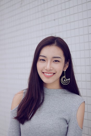 Photo Of Woman Standing Beside White Wall