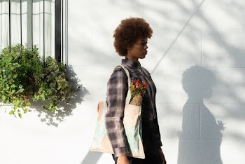 Photo Of Woman Standing Beside White Wall