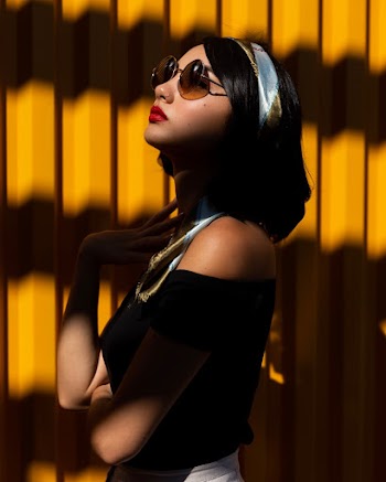 Photo Of Woman Standing Beside Yellow Wall