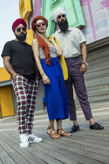 Photo of Woman Standing in Between Two Indian Men with Turbans