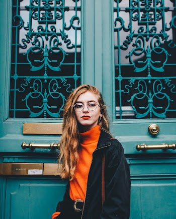 Photo of Woman Standing In Front of a Blue Door
