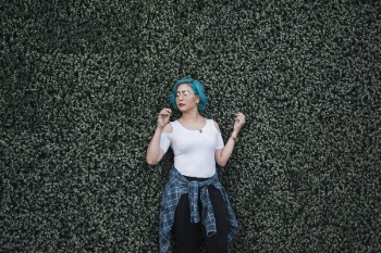 Photo of Woman Standing In Front Of Bush
