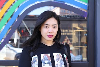 Photo of Woman Standing in Front of Glass Window