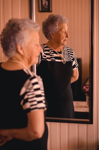 Photo of Woman Standing In Front Of Mirror