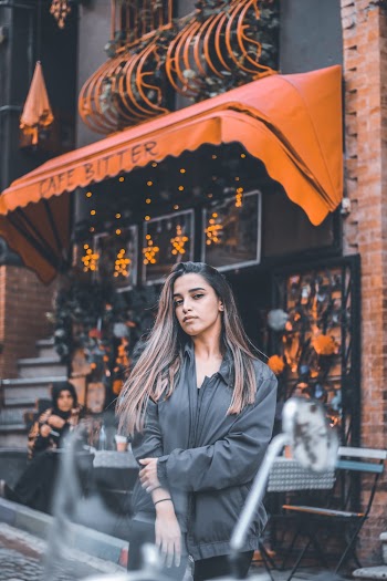 Photo Of Woman Standing In Front Of Store