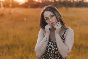 Photo of Woman Standing in Grass Field Posing during 