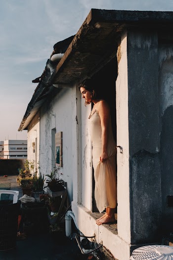 Photo Of Woman Standing In The Doorway
