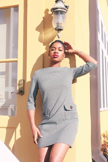 Photo of Woman Standing Near a Yellow Building